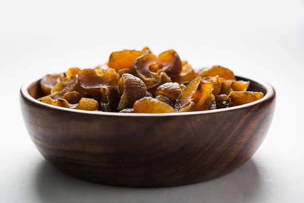 Ayurvedic Amla Candy, which is dried and salty-sweet or chatpata in taste and digestive. Served in a wooden bowl, selective focus