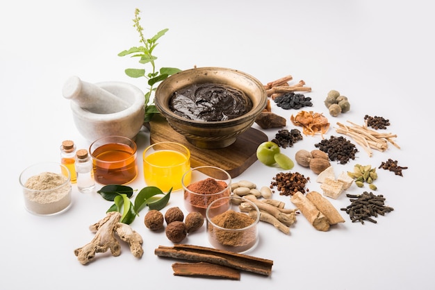 Ayurvedic Chyawanprash is a Powerful  Immunity Booster OR Natural Health Supplement. Served in an Antique bowl with Ingredients, over moody background, selective focus