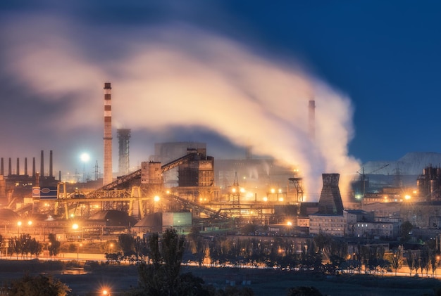 Azovstal in Mariupol Ukraine before war Steel plant at night Steel factory with smokestacks Steel works iron works Heavy industry Industrial landscape with metallurgical combine smokes lights