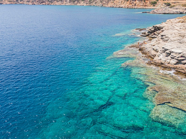 Azure water texture transparent sea surface with a rocky bottom Aerial view natural blue background