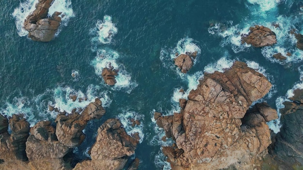 Azure waves foaming rocks top view relaxing blue ocean rolling washing cliffs