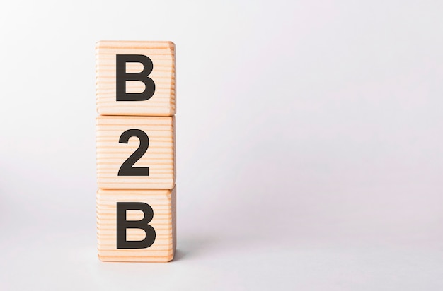 B2B letters of wooden blocks in pillar form on white