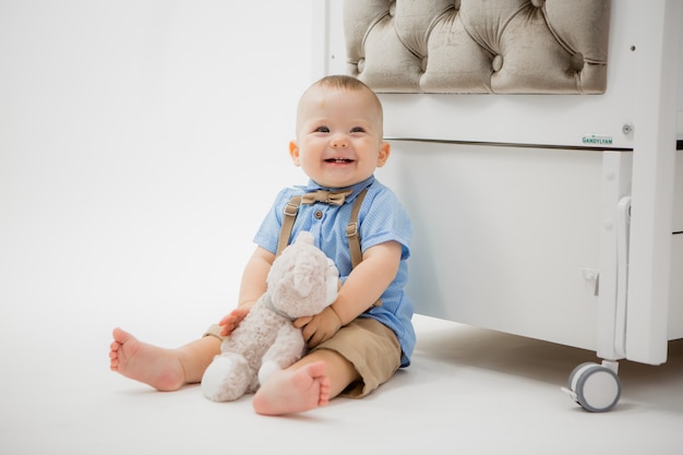 baby in a baby bed on grey