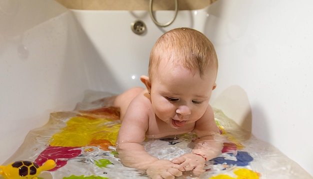 Baby bathes in the bath selective focus