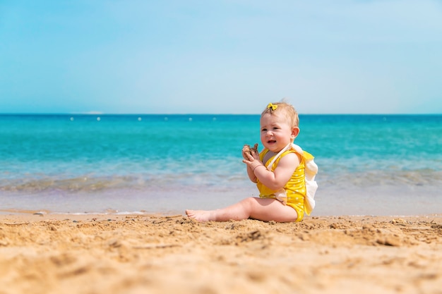 Baby on the beach near the sea