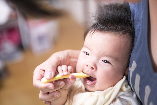 A baby being fed with a spoon