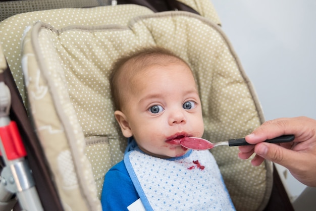 Baby blue eyed boy eating baby baby