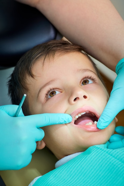 Baby boy at the dentist the reception opened his mouth in  clini