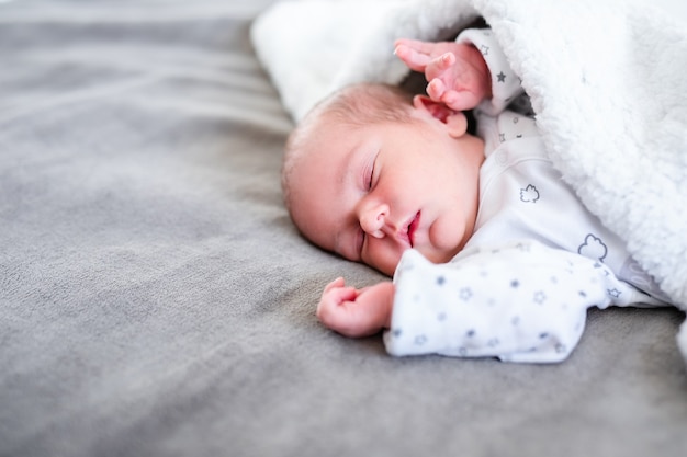 Baby boy sleeping first days of life. Cute little newborn child sleeping peacefully.