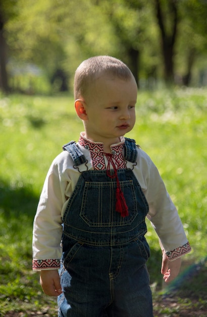 Baby boy in Ukrainian vyshyvanka in the park