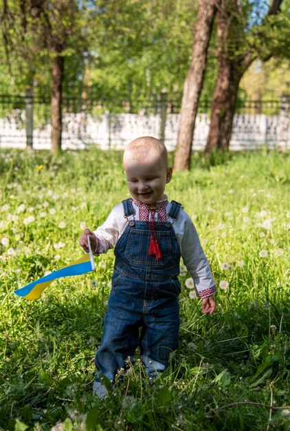 Baby boy in Ukrainian vyshyvanka in the park