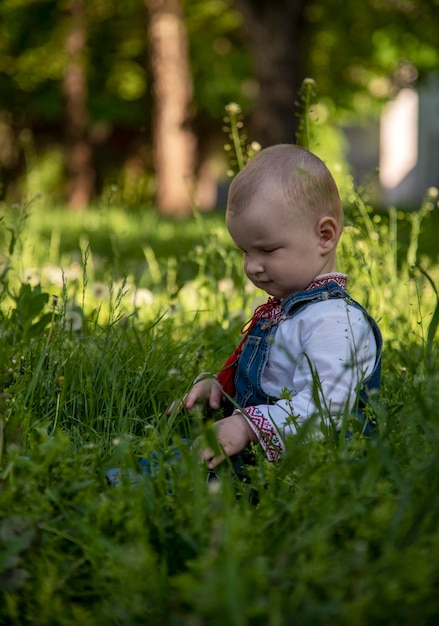 Baby boy in Ukrainian vyshyvanka in the park