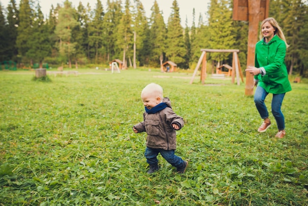 Baby boy walking at autum park