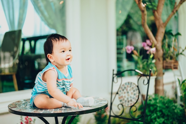 Baby at cafe outdoors. Portrait of happy kid