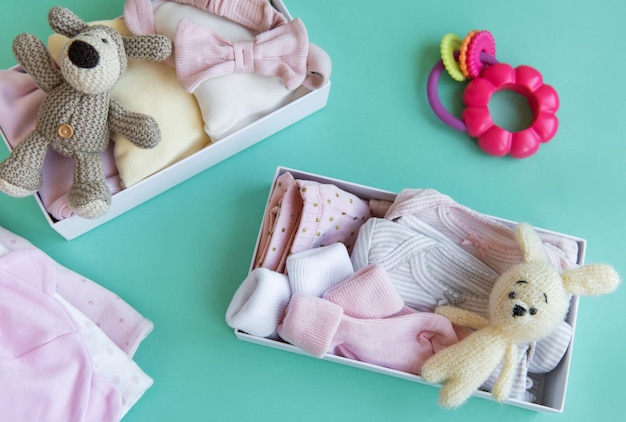 Photo baby and child clothes and knitted toys in carton box