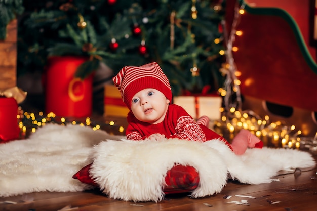 Baby next to the Christmas tree