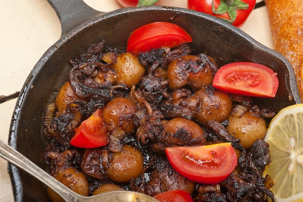 Baby cuttle fish roasted on iron skillet