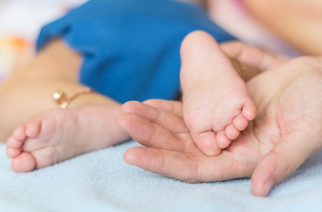 Baby feet on the mothers hand