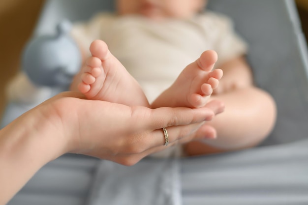 Baby feet in mothers hands maternal love for her baby maternity leave motherhood happy childhood con