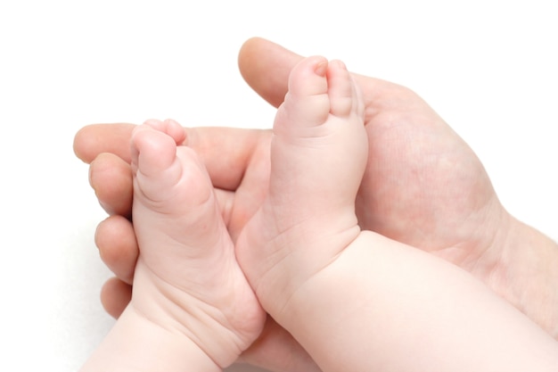 Baby feets lying on a father`s hand