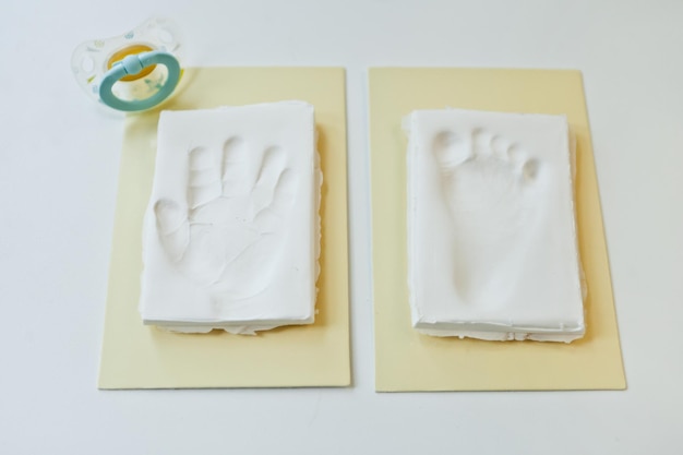 Baby footprint and handprint on clay mold plaque To remember in the future how small the baby was cheerful childhood celebration event Baby DIY keepsake to keep forever