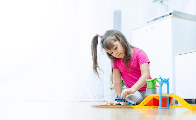 baby game. Little clever caucasian child playing colorful toy railway and train for early development. Preschooler kids leisure.