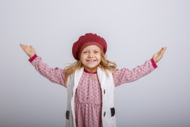 baby girl in  autumn beret on grey background