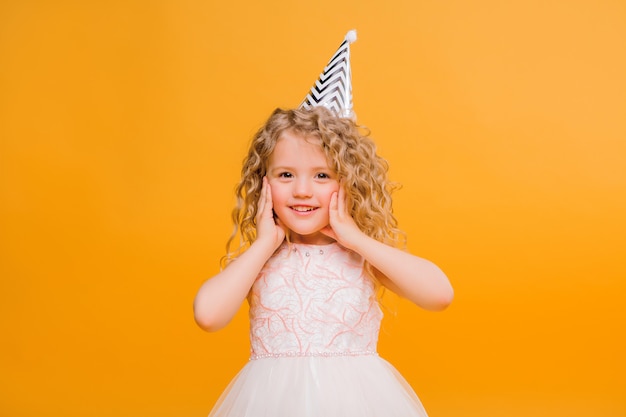 baby girl birthday smiling on orange