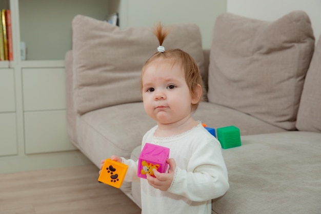 Baby girl at home playing dice child development