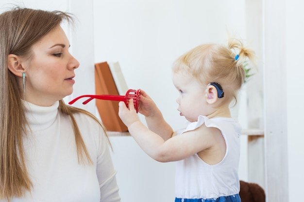 Photo baby girl wearing a hearing aid.