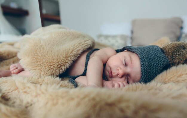 Baby girl with pompom hat sleeping