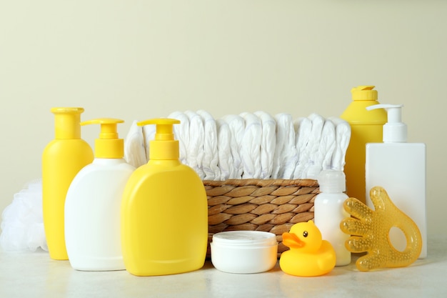 Baby hygiene accessories on white textured table