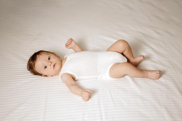 A baby is lying on the bed