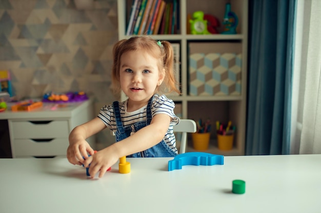 The baby is playing at the table Early child development