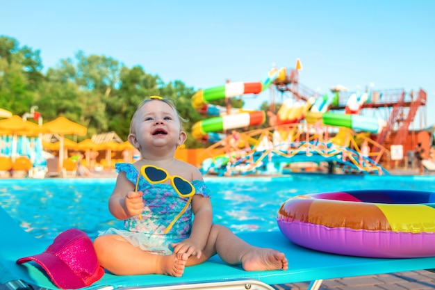 Baby is sitting by the pool. Selective focus. Child.