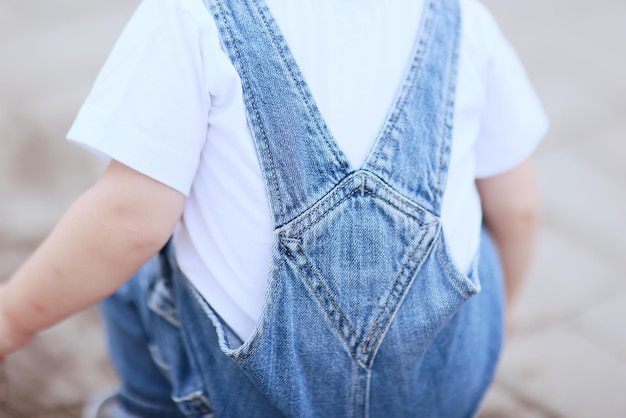 baby jeans jumpsuit boy walks in summer