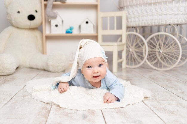 Baby lies at home in the children's room with toys, development concept and games