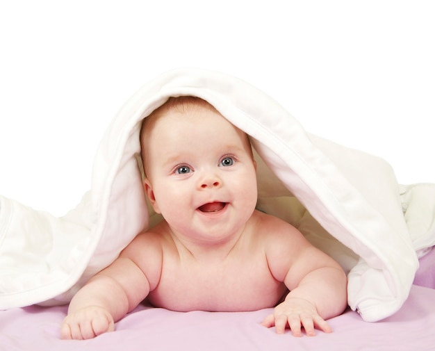 Baby looking out from under blanket