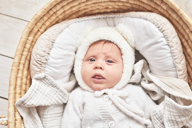 Baby lying in wicker cradle Happy Mother's and Father's Day Childhood and parenthood