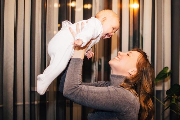 baby in moms arms smiling