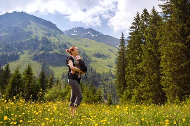 Baby and mother with the Alps mountains in nature in the Background