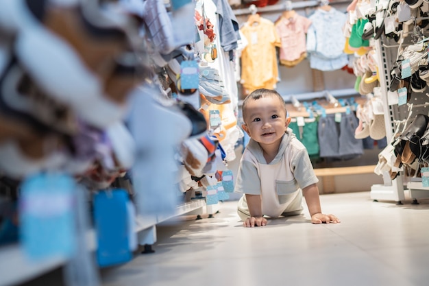 Photo baby playing and crawling in the store while shopping