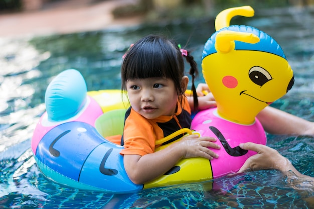 baby playing water in pool