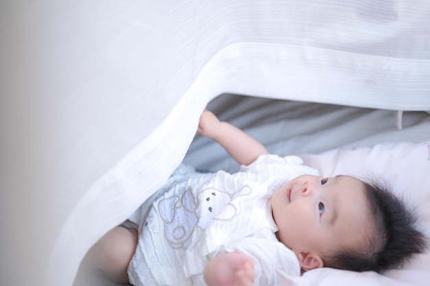 Baby playing with curtains