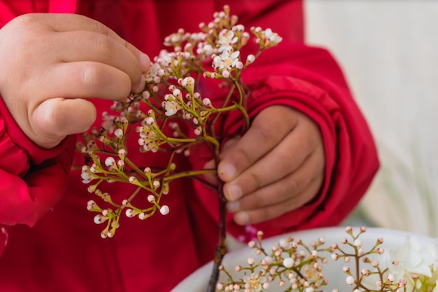 Baby playing with flowers outside activity fine motor skills development