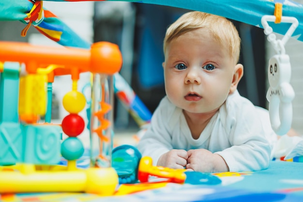 A baby plays on a developmental mat for two months Toy rug for small children