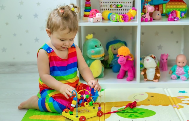 Baby plays with toys in the room Selective focus