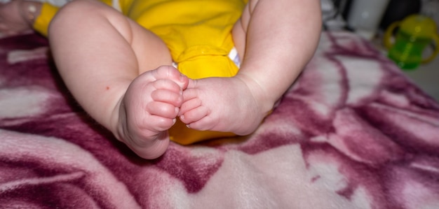 A baby's foot is visible on a blanket.