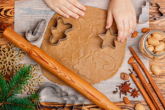 Baby's hands makes traditional gingerbreads . Christmas. New year 