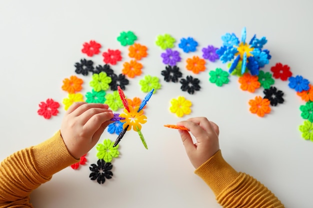 Photo baby's hands and mosaics toys for the development of fine motor skills and creative thinking